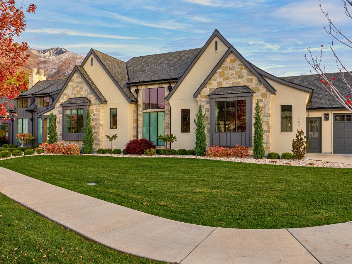 Stone home in daylight with Trimlight track installed and nearly invisible