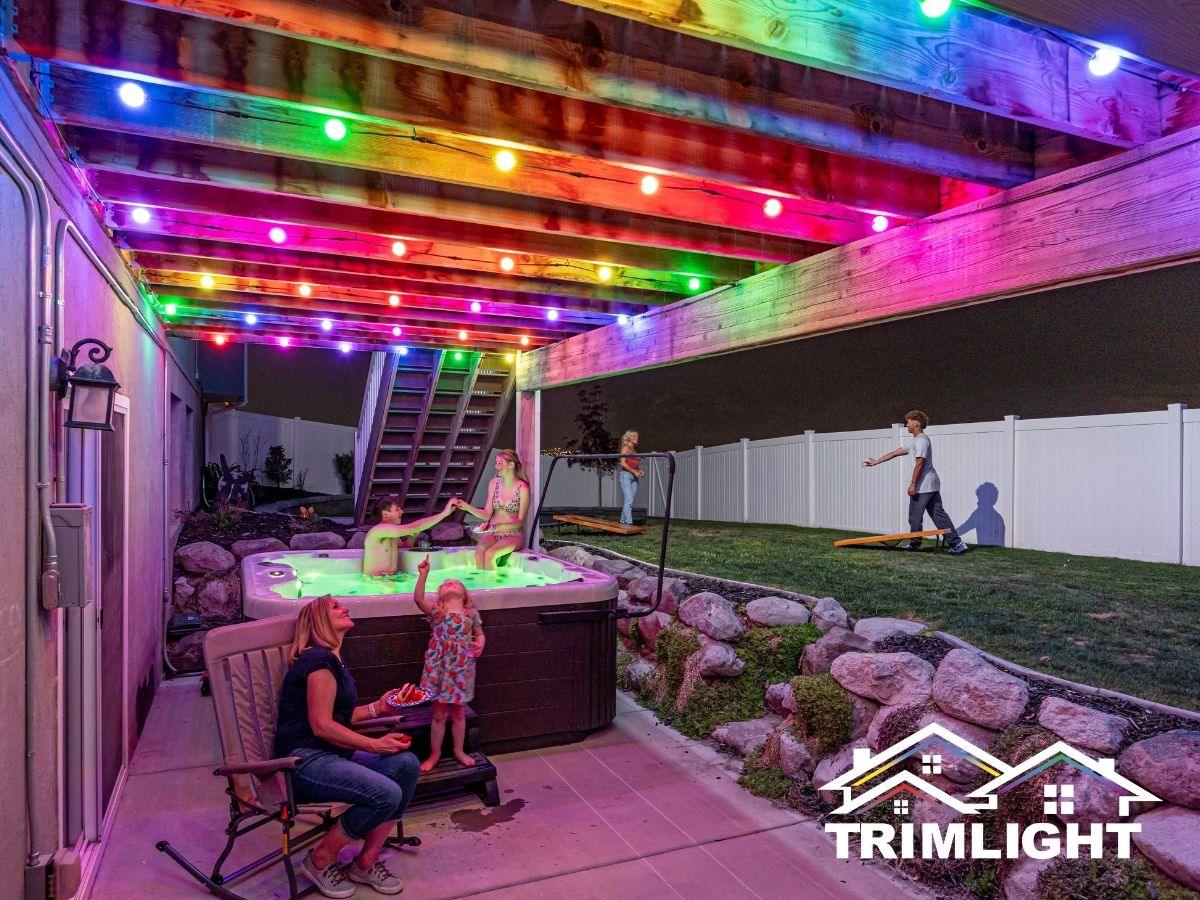 Multicolor globe lights under a backyard pergola