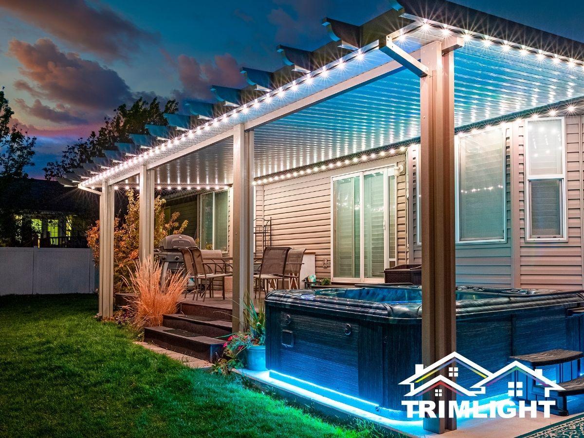 Permanent patio lights on a pergola over a hot tub and deck