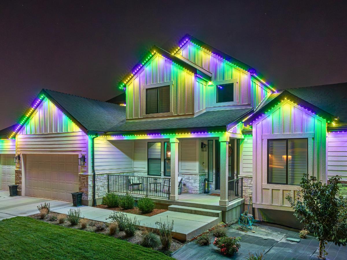 Rainbow color chase permanent lights on a two-story home